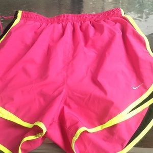 Pink yellow and black nike shorts